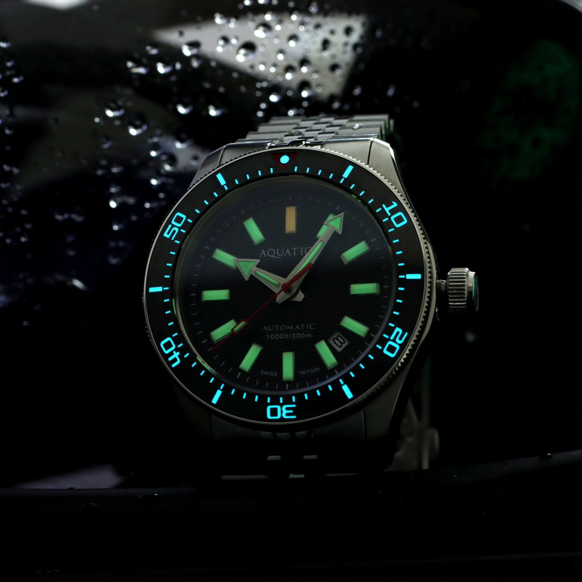Aquatico Sea Recon tritium watch with illuminated hands, markers and bezel in darkness