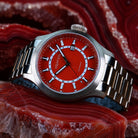 Luxury bronze watch featuring a deep red agate stone dial