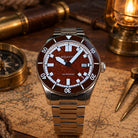 Close-up of red aventurine watch dial with luminous hands