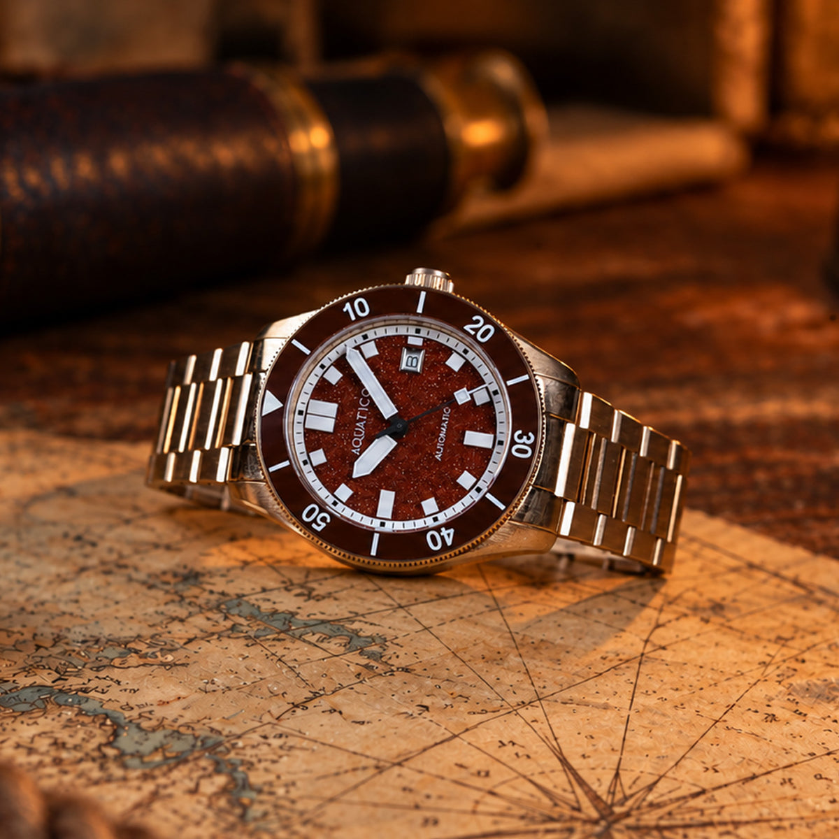 Red aventurine dial bronze mechanical watch close-up