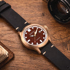 Close-up of a red aventurine watch dial, revealing its fiery red tones and natural mineral shimmer.